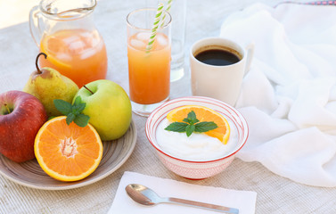 Healthy breakfast concept yogurt, fruits, fresh juice and coffee.