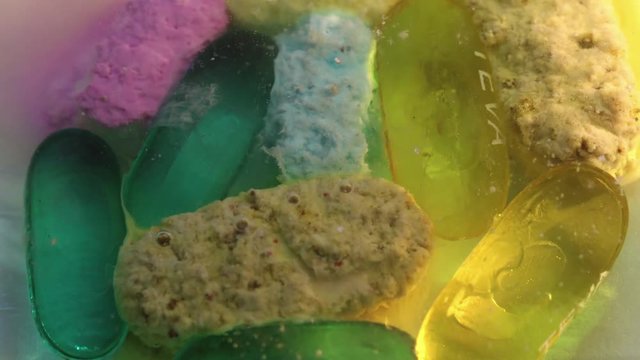 Timelapse, pills dissolve in water