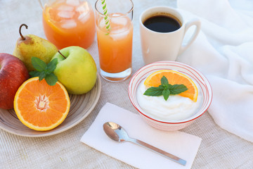 Healthy breakfast concept yogurt, fruits, fresh juice and coffee.