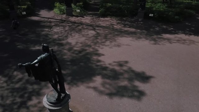 Bronze statues standing in the forest in the thicket among the trees of different gods male female statues of the Venus Zeus Cupid
