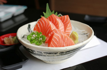 Sliced salmon raw sashimi on ice.