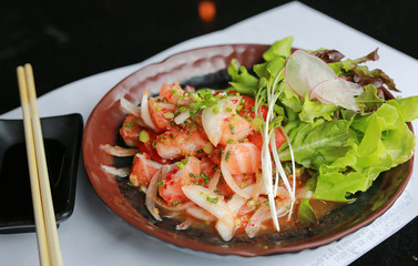 Fresh salmon raw spicy salad - Fusion food style.