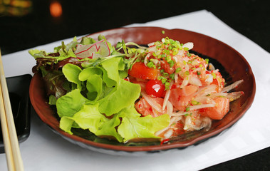 Fresh salmon raw spicy salad - Fusion food style.