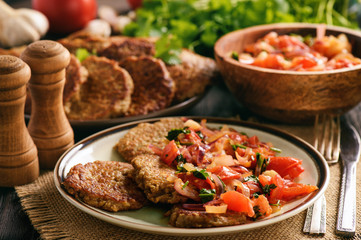 Eggplant fritters served with stewed tomatoes and onion, vegetarian food.