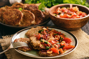 Eggplant fritters served with stewed tomatoes and onion, vegetarian food.
