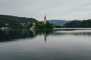 Naklejka premium Bled Castle and Church on the Island on the Lake Bled, Slovenia.