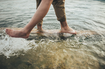 Legs of a young couple in the water