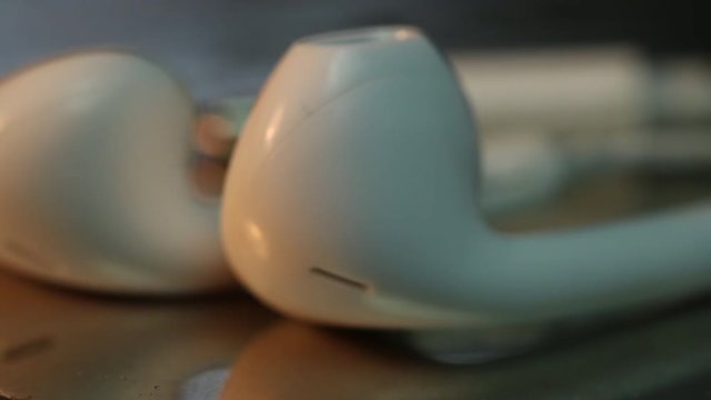 Music headphones rotate on display, extreme close up
