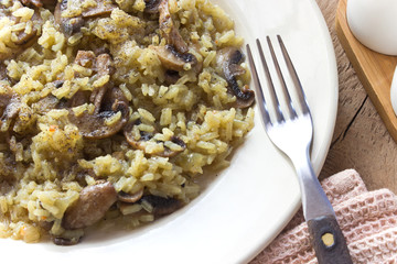 Risotto with mushrooms on plate with fork