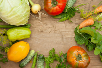 SUMMER VEGETABLES ON A WOODEN BACKGROUND