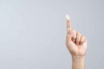 Hand with petroleum jelly on index finger