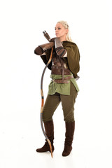 full length portrait of a blonde girl wearing green and brown medieval costume, holding a bow and...