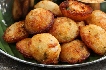 Kuzhi Paniyaram served with coconut chutney and sambar- South Indian breakfast with black  lentils and rice