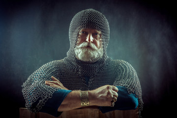 Powerful bearded knight on the dark background.