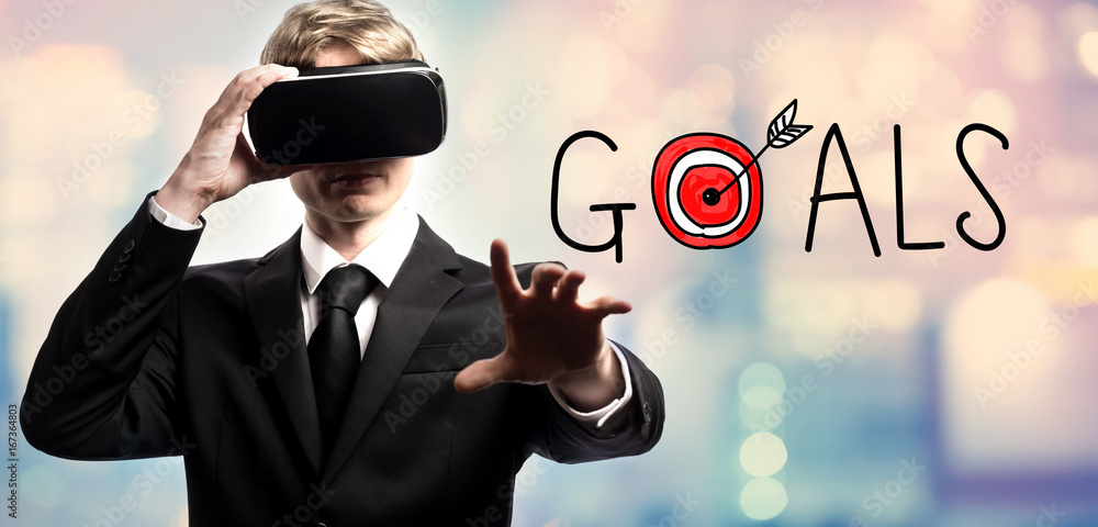 Poster goals text with businessman using a virtual reality headset