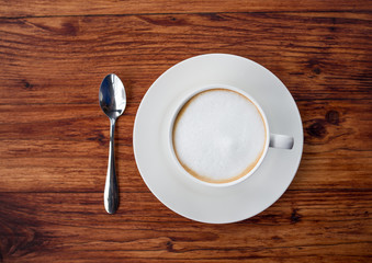 A cup of hot coffee on brown wooden floor for drinking.