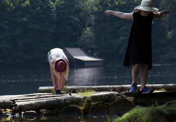 Girls playing on dock on lake