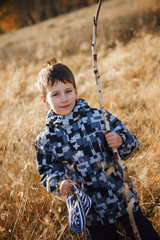 Photo of cute little boy enjoying autumnal nature