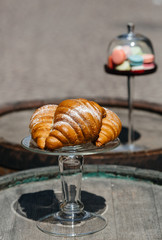 Tasty buttery  croissants  and macaroons on table