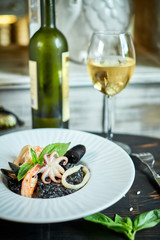 Dish of risotto with squid ink on grey plate jpg