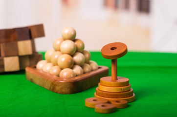 Wooden Brain Teaser or Wooden Puzzles on green floor in blurred background