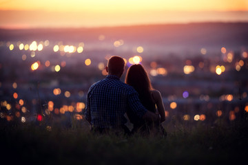 Lovers man and girl against background night city, night starry sky and horizon. Concept date...