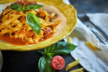 Italian penne pasta with tomatoes and pesto in a restaurant jpg