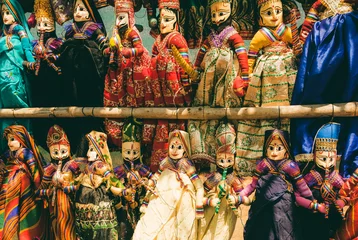 Fotobehang Indian market showcase with funny handmade dolls in traditional costumes. Marketplace with old style toys for children in India © radiokafka
