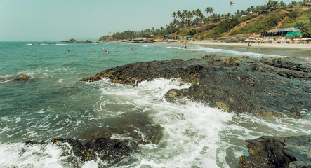 Panoramic view on wave of ocean waters and palm trees beach. Asian holiday landscape