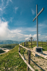 jesuscross on top of mountain with blue sky and clouds