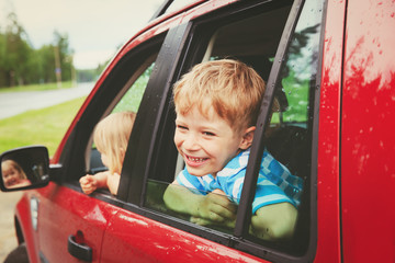 happy little boy and girl travel by car