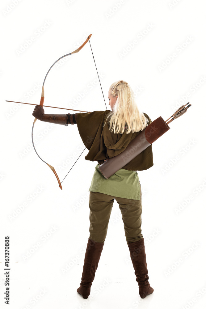 Sticker full length portrait of a blonde girl wearing green and brown medieval costume, holding a bow and arrow. isolated on white background.