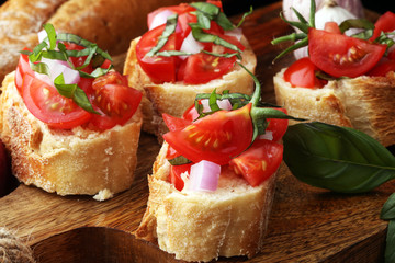 Bruschetta with tomatoes, herbs and oil on toasted garlic cheese bread toasted with chopped tomatoe
