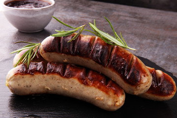 Grilled sausages with sauce ketchup on a wooden table - Home-made Pork Sausages