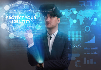 Business, Technology, Internet and network concept. Young businessman working on a virtual screen of the future and sees the inscription: Protect your identity