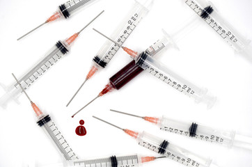 Syringe with blood on a white background photo