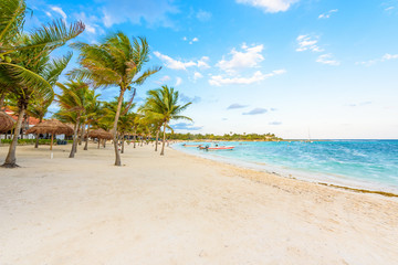 Obraz na płótnie Canvas Beautiful white sand beach in Akumal, Mexico - paradise bay Beach in Quintana Roo - caribbean coast - late afternoon and sunset at Riviera Maya