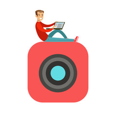 Young smiling man sitting on a big mobile app symbol and using his laptop colorful character vector Illustration