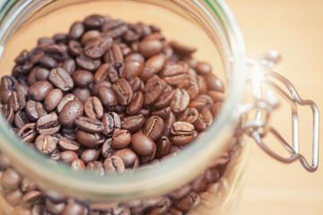 Coffee beans in glass jar. Shallow dof
