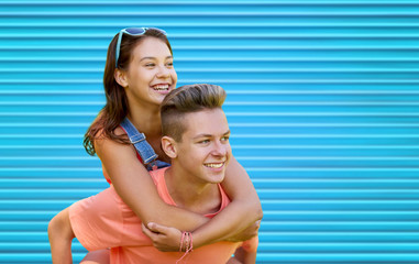 happy teenage couple having fun over blue