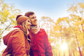 happy young couple walking in autumn park