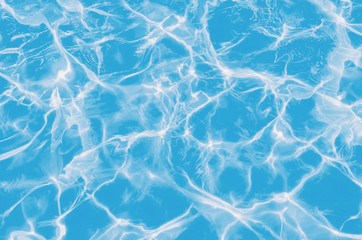 Solar flares on the blue water in the pool