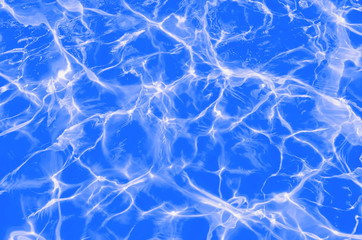 Fototapeta na wymiar Solar flares on the blue water in the pool