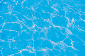 Solar flares on the blue water in the pool