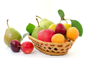 Fruit composition  - wicker wooden basket with whole ripe fruit on a white background
