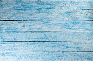 Painted in blue and white color wall with wooden planks.
