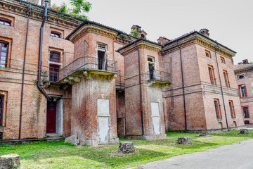 Abandoned and ruined buildings of the ancient damaged Cittadella of Alessandria in Italy. HDR effect.