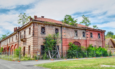 Abandoned and ruined buildings of the ancient damaged Cittadella of Alessandria in Italy. HDR effect.