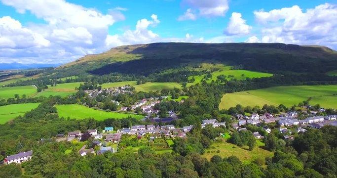 4K aerial footage of the rural village of Fintry in Scotland nestled beneath the Campsie Fells and Fintry Hills