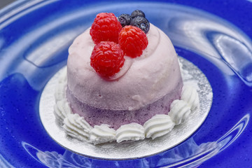 Italian semifreddo made with blueberry and raspberry on blue background. HDR effect.